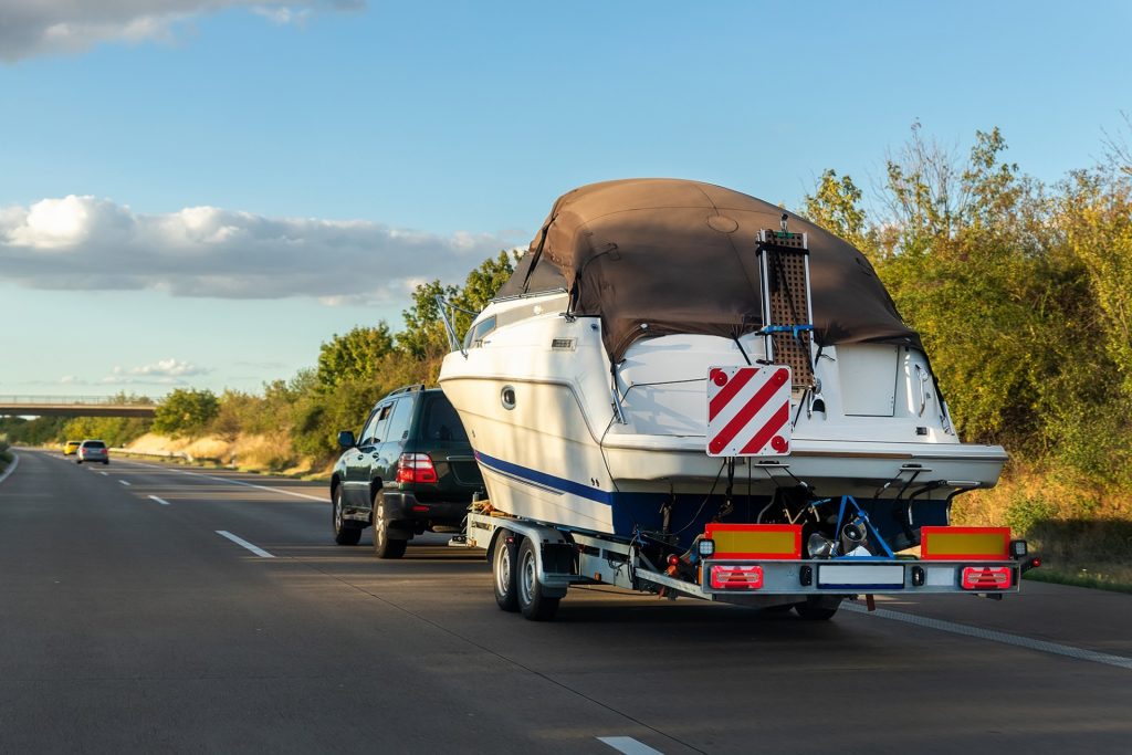 suv pulling a boat on a trailer